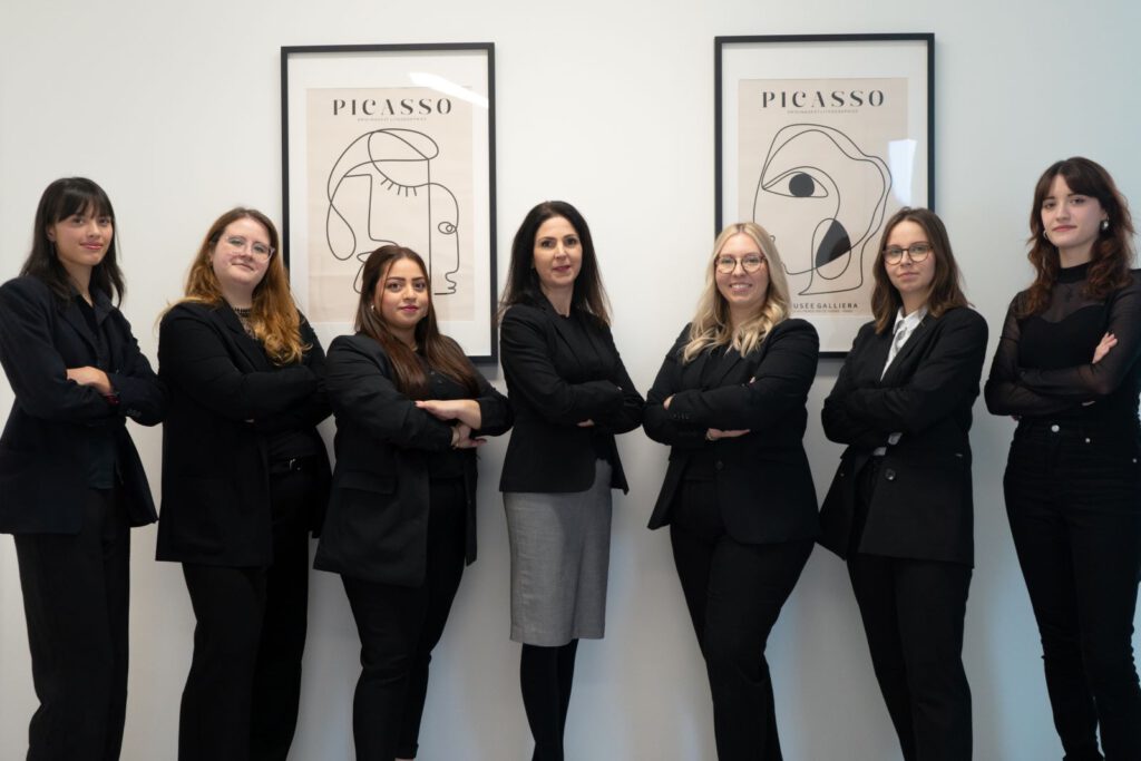 Luxregia Heimtier-Team in schwarzer Businesskleidung vor Wandbildern mit Picasso-Grafik und hellem Hintergrund – mit Bezug zu NutriQM.